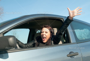 Angry young woman screaming in the car
